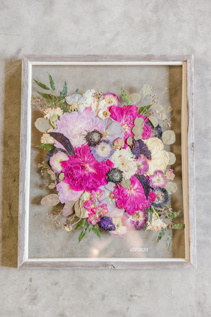 Colorful pressed flowers in a barn wood frame with a wedding date addition, created by Element, previously known as Pressed Bouquet Shop. 