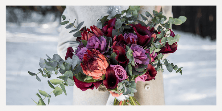 Deep purple and orange winter wedding bouquet 