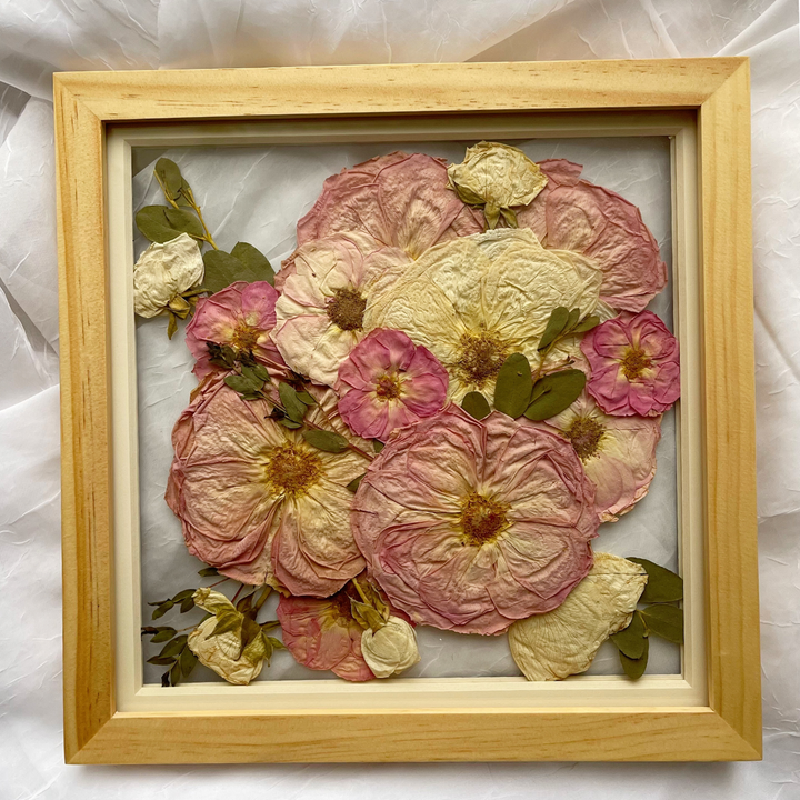 10x10 traditional burst style design using pressed roses and greens in a natural-colored glass float frame
