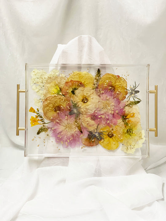A finished look at a preserved bouquet in a serving tray with gold handles and gold metallic flakes made by Element Preservation.
