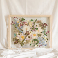 Wedding bouquet pressed and preserved in a floating frame made of natural colored wood. 