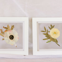 Two 6x6" mini white wood frames with a pressed boutonniere