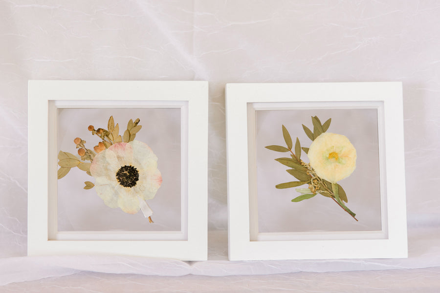 Two 6x6" mini white wood frames with a pressed boutonniere