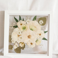 Sentimental white pressed flowers designed in a square white 10 inch frame. 