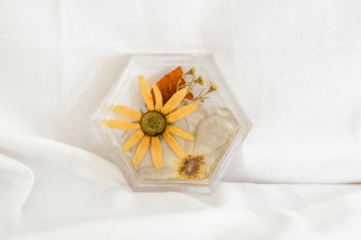 A neutral pressed flower ring dish in the shape of a hexagon, created by Element previously known as Pressed Bouquet Shop.