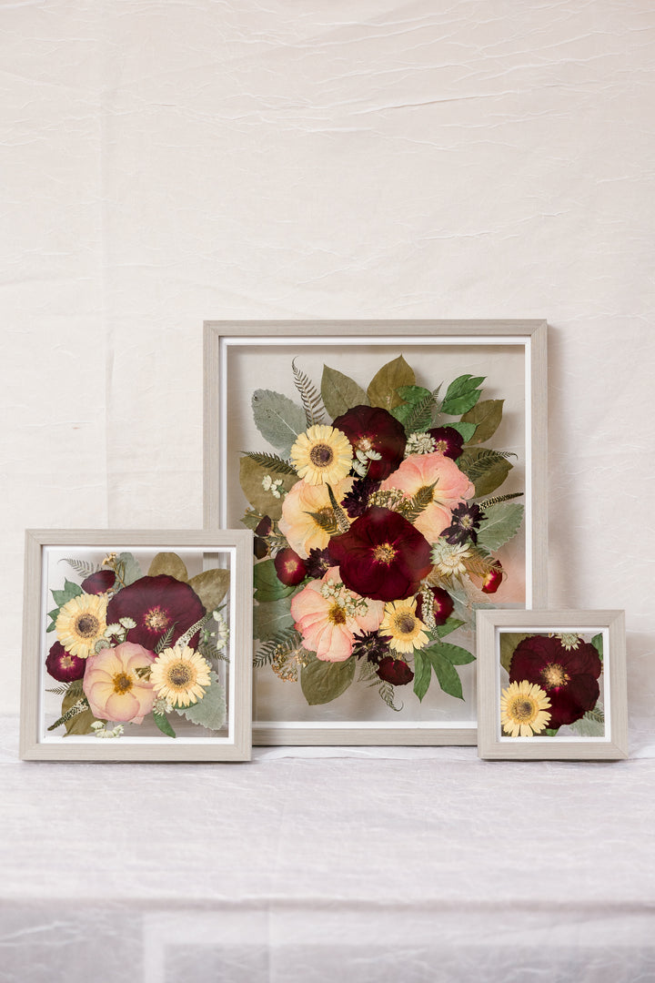 Three grey wood pressed flower frames featuring flowers from a wedding bouquet, made by Element Design Co, previously Pressed Bouquet Shop