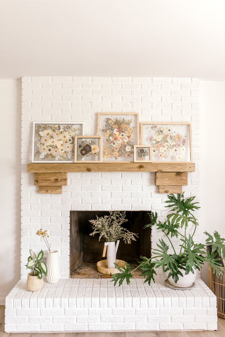 Pressed Bouquet Shop's frames on mantle in a home