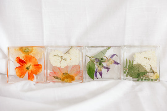 Brightly colored pressed flowers in resin coasters preserved by Element Design Co.