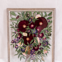 A cascading bouquet that was pressed into a barn wood frame. 