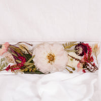 Flowers from a pink and white wedding bouquet preserved as a functional piece of home decor. 