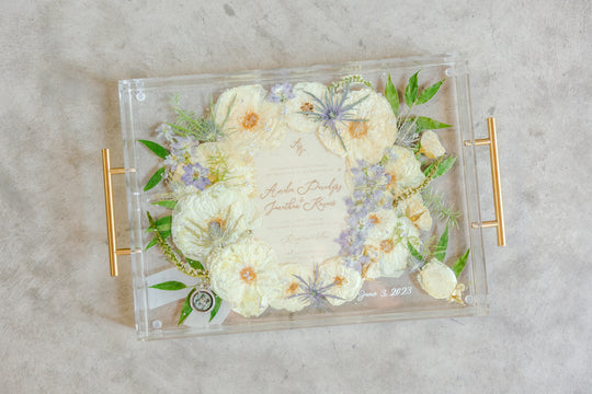 Serving tray with pressed flowers from a wedding bouquet, including a wedding invitation created by Element, previously known as Pressed Bouquet Shop. 