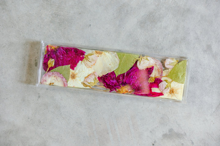 A white, pink, and green pressed floral display tray handmade by Element, previously known as Pressed Bouquet Shop. 
