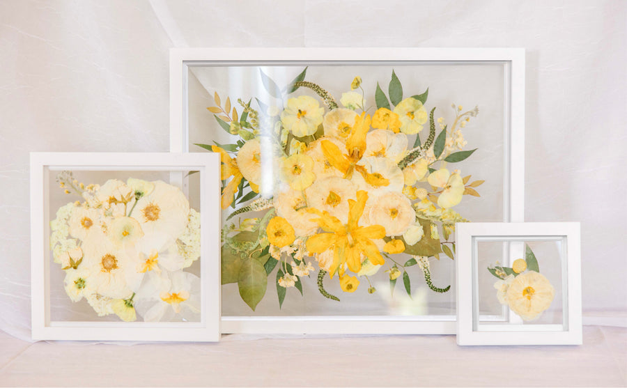 The Gallery Bundle Deal with all white wood frames filled with pressed wedding bouquet flowers