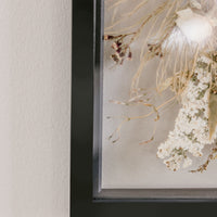Close-up of Pressed Bouquet Shop's 16x20 black wood frame