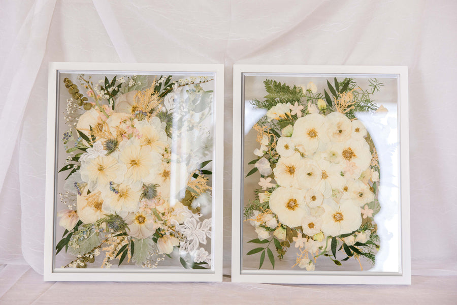 Two white wedding bouquets pressed in a 16x20" white wood frame